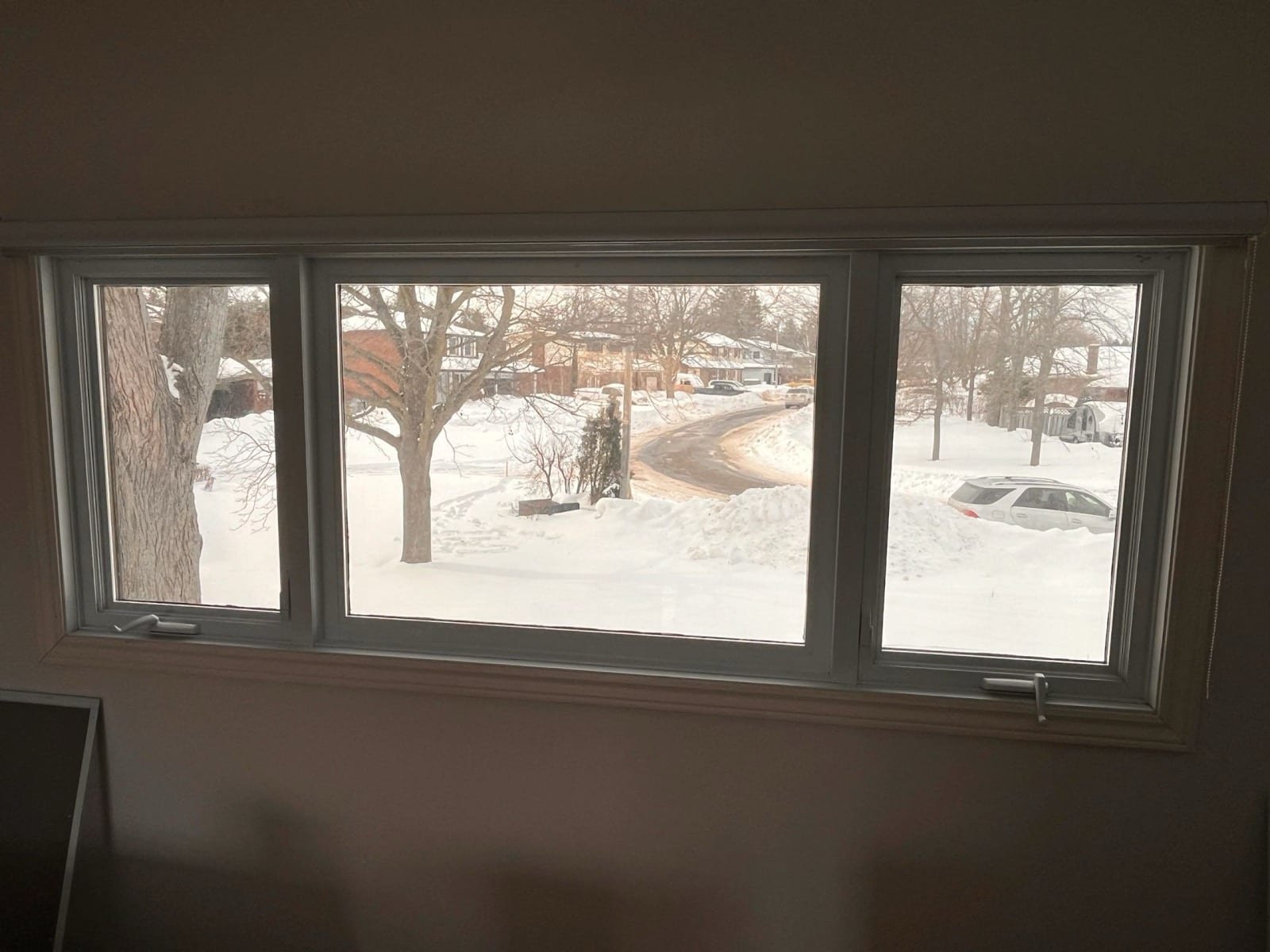 Interior view through filmed windows onto a snowy street